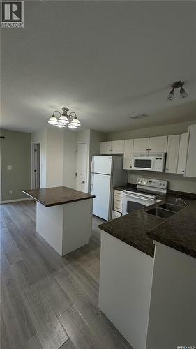 13 1437 1St Street, Estevan, SK - Indoor Photo Showing Kitchen With Double Sink
