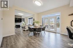 Open concept living area featuring wood-finish flooring throughout - 