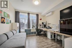 Bright room with wood-finish flooring and large windows - 