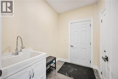 Utility sink with chrome gooseneck faucet and white cabinetry - 6 Dorothys Drive, Oro-Medonte, ON - Indoor