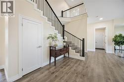 Two-story staircase with dark metal balusters and white risers - 