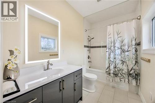 Modern bathroom featuring a rectangular vanity with a white countertop and dark cabinetry - 6 Dorothys Drive, Oro-Medonte, ON - Indoor Photo Showing Bathroom