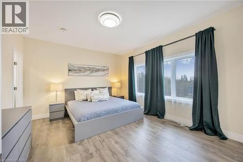 Spacious room featuring wood-finish flooring, a contemporary ceiling light fixture, and crown molding - 6 Dorothys Drive, Oro-Medonte, ON - Indoor Photo Showing Bedroom
