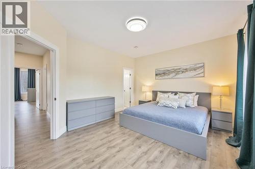 Spacious room featuring wood-finish flooring, a contemporary flush-mount ceiling light, and light-colored walls - 6 Dorothys Drive, Oro-Medonte, ON - Indoor Photo Showing Bedroom
