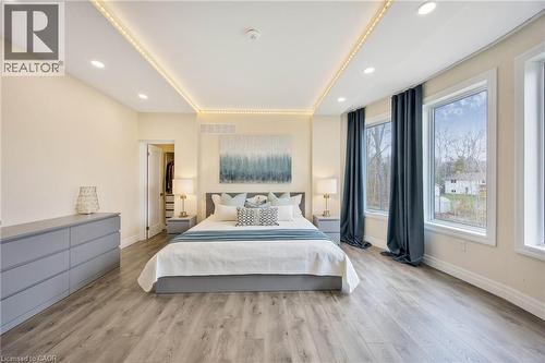Bedroom featuring wood-finish flooring, recessed lighting, and tray ceiling with perimeter lighting - 6 Dorothys Drive, Oro-Medonte, ON - Indoor Photo Showing Bedroom
