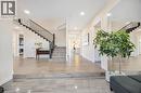 Spacious entryway featuring large format tile flooring, wood-finish flooring, a contemporary staircase with black railings, recessed lighting, and crisp white trim - 6 Dorothys Drive, Oro-Medonte, ON  - Indoor Photo Showing Other Room 