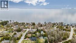 Aerial perspective showcasing a waterfront community with numerous residential properties - 