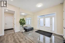 Entryway featuring a double door with frosted glass panels, two sidelights, and a transom window - 