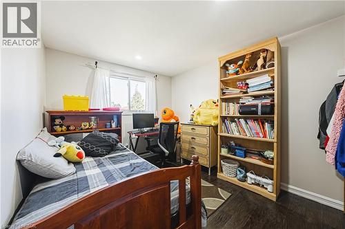 Bright room featuring a window with white curtains, dark wood-finish flooring, and recessed ceiling lighting - 235 Larch Street, Hamilton, ON - Indoor