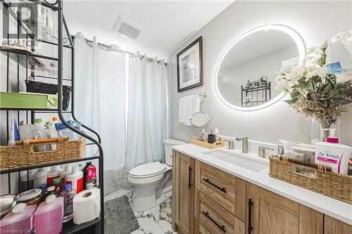 Bathroom featuring a light wood-finish vanity with a white countertop and rectangular undermount sink - 235 Larch Street, Hamilton, ON - Indoor Photo Showing Bathroom