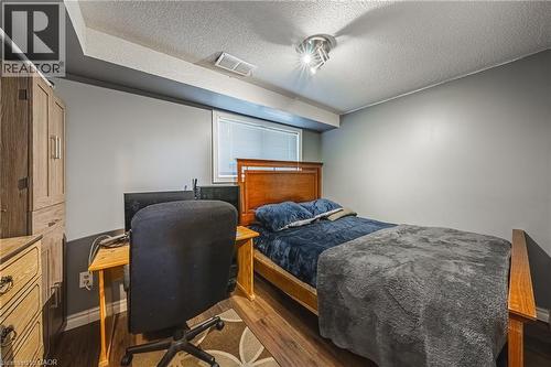 Room featuring neutral gray walls and wood-finish flooring - 235 Larch Street, Hamilton, ON - Indoor