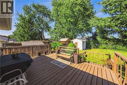 Expansive wood-finish deck with railing overlooking a green lawn - 235 Larch Street, Hamilton, ON - Outdoor With Deck Patio Veranda