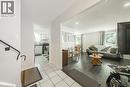 Open concept living area with dark wood-finish flooring - 235 Larch Street, Hamilton, ON  - Indoor 