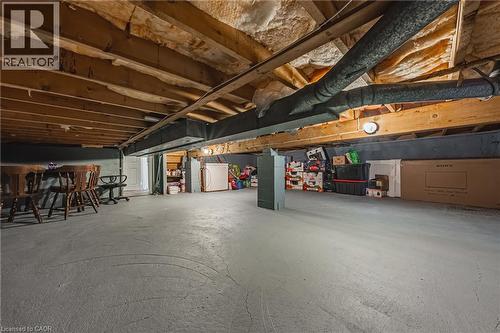 Unfinished basement featuring exposed wood joists, structural beams, and concrete flooring - 235 Larch Street, Hamilton, ON - Indoor