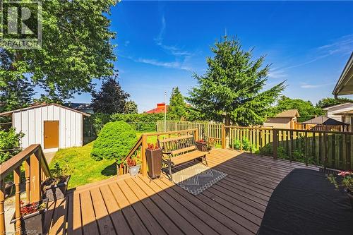 Expansive wood deck with natural wood railing overlooking a fenced yard - 235 Larch Street, Hamilton, ON - Outdoor With Deck Patio Veranda