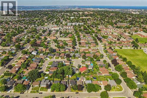 Expansive suburban residential area featuring numerous detached homes, mature tree coverage, and a distant body of water - 235 Larch Street, Hamilton, ON - Outdoor With View