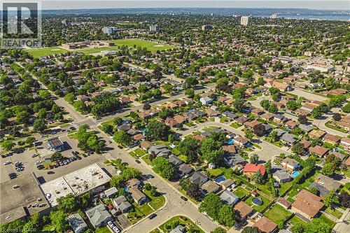 Aerial perspective showcasing a residential area with varied housing styles and mature tree coverage - 235 Larch Street, Hamilton, ON - Outdoor With View