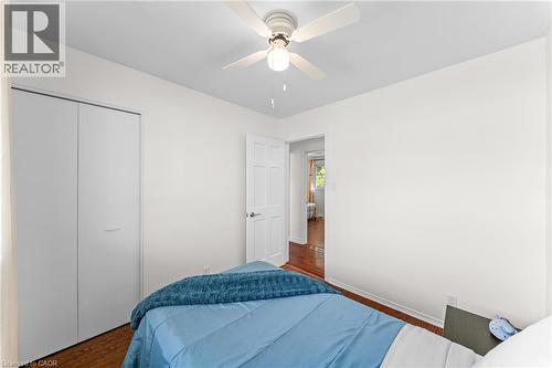 Interior room featuring wood-finish flooring and a ceiling fan with integrated lighting - 183 Harvard Road, Waterloo, ON - Indoor Photo Showing Bedroom