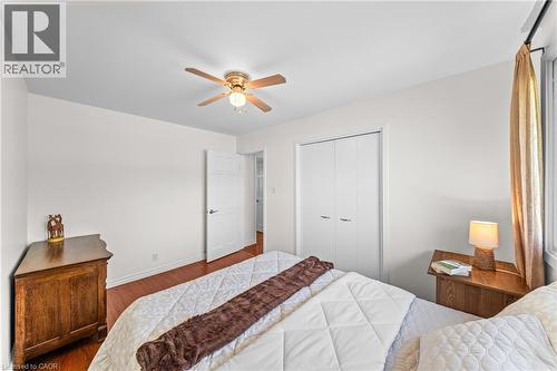 Bedroom featuring wood-finish flooring, white walls, and a ceiling fan with integrated lighting - 183 Harvard Road, Waterloo, ON - Indoor Photo Showing Bedroom