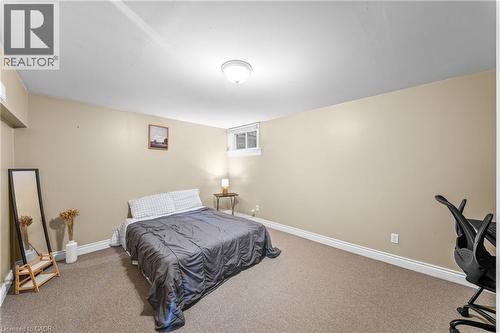 Carpeted room with neutral-toned walls, white trim, and a ceiling-mounted flush light fixture - 183 Harvard Road, Waterloo, ON - Indoor