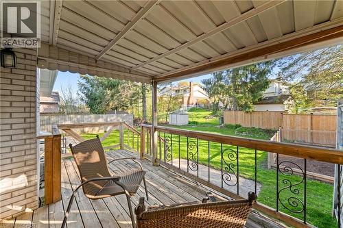 Covered outdoor deck with wood-finish flooring and an ornate metal railing - 183 Harvard Road, Waterloo, ON - Outdoor With Deck Patio Veranda With Exterior