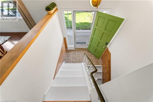 Entryway featuring a vibrant green paneled door, sidelight windows, and tiled flooring - 183 Harvard Road, Waterloo, ON - Indoor Photo Showing Other Room