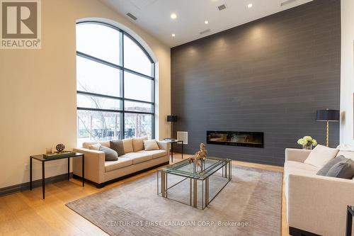 208 - 260 Villagewalk Boulevard, London North (North R), ON - Indoor Photo Showing Living Room With Fireplace