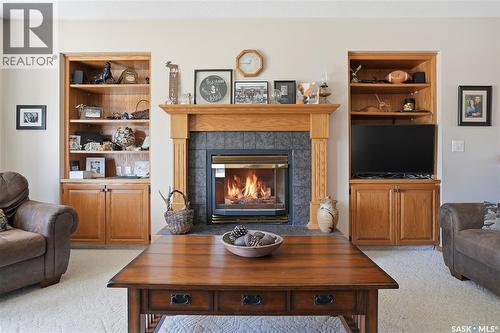 403 Willow Bay, Balgonie, SK - Indoor Photo Showing Living Room With Fireplace