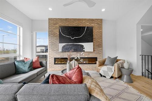 102 Butterfly Way, Winnipeg, MB - Indoor Photo Showing Living Room With Fireplace