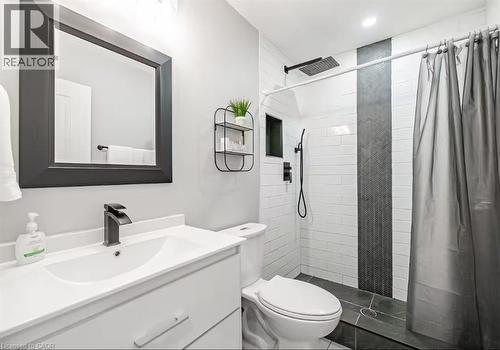 Bathroom featuring a white vanity with a rectangular sink and a matte black faucet - 88 South Bend Road E Unit# Unit A, Hamilton, ON - Indoor Photo Showing Bathroom