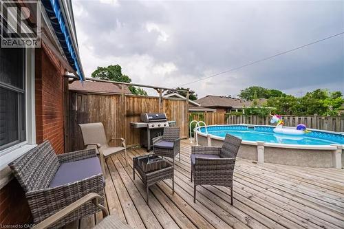 Expansive wood-finish deck featuring an above-ground pool and a brick exterior - 88 South Bend Road E Unit# Unit A, Hamilton, ON - Outdoor With Above Ground Pool With Deck Patio Veranda