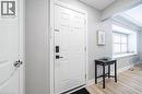 Entryway featuring a paneled door with smart lock, light wood-finish flooring, and a window with plantation shutters - 88 South Bend Road E Unit# Unit A, Hamilton, ON  - Indoor Photo Showing Other Room 