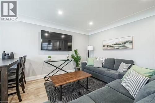Open-concept living area featuring light wood-finish flooring, recessed lighting, and crown molding - 88 South Bend Road E Unit# Unit A, Hamilton, ON - Indoor Photo Showing Living Room