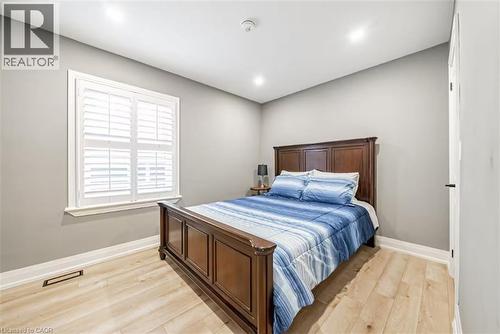 Room featuring light wood-finish flooring, white plantation shutters, recessed lighting, and crisp baseboards - 88 South Bend Road E Unit# Unit A, Hamilton, ON - Indoor Photo Showing Bedroom