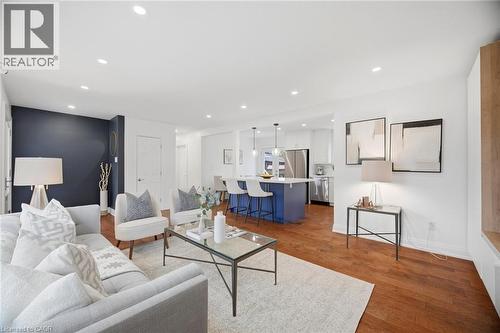 Open-concept living area featuring rich wood-finish flooring, recessed lighting, and a contrasting accent wall - 1376 Royal Drive, Burlington, ON - Indoor Photo Showing Living Room
