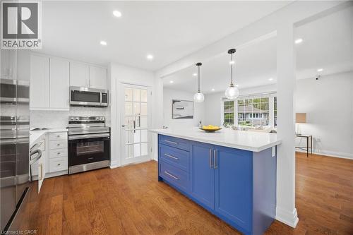 Kitchen featuring a blue island with a white countertop and pendant lighting - 1376 Royal Drive, Burlington, ON - Indoor Photo Showing Kitchen With Upgraded Kitchen