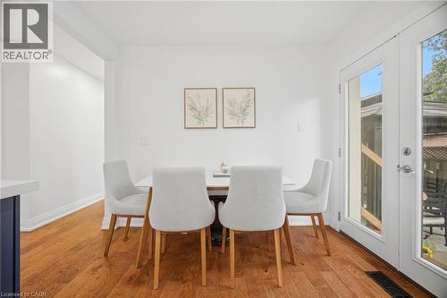 Dining area featuring wood-finish flooring, white walls, and bright patio doors - 1376 Royal Drive, Burlington, ON - Indoor Photo Showing Dining Room