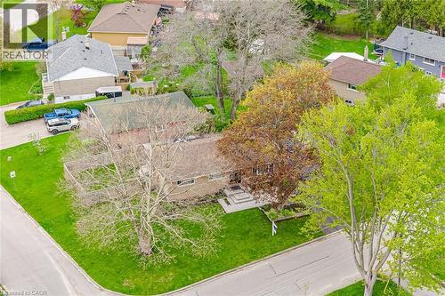 Expansive corner lot featuring a mature deciduous tree, a paved driveway, and a front entry with concrete steps - 1376 Royal Drive, Burlington, ON - Outdoor