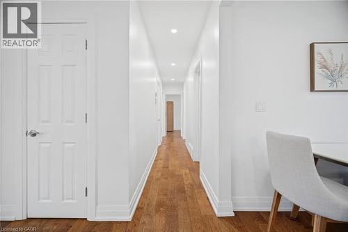 Hallway featuring wood-finish flooring, recessed lighting, white trim, and a white six-panel door - 1376 Royal Drive, Burlington, ON - Indoor Photo Showing Office