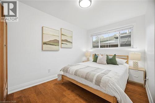 Bright room featuring wood-finish flooring, white walls, and a recessed window - 1376 Royal Drive, Burlington, ON - Indoor Photo Showing Bedroom