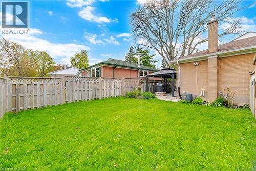 Expansive green lawn surrounded by a privacy fence with lattice detailing - 1376 Royal Drive, Burlington, ON - Outdoor