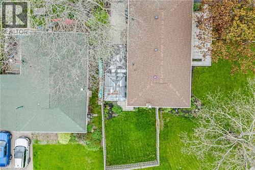 Property featuring a brown shingle roof, a green shingle roof, and an expansive grassy lawn - 1376 Royal Drive, Burlington, ON - Outdoor
