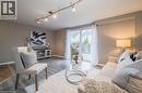 Open-concept living space with wood-finish flooring, neutral wall tones, and recessed track lighting - 27 Max Becker Drive, Kitchener, ON  - Indoor Photo Showing Living Room 