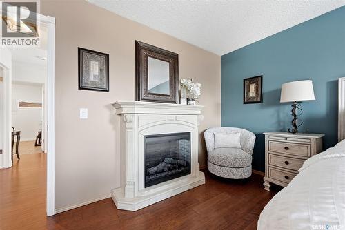 3234 Peyson Bay E, Regina, SK - Indoor Photo Showing Bedroom With Fireplace