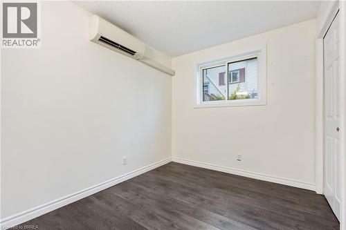 Room featuring wood-finish flooring, white baseboards, and a window with white trim - 9 Cherry Street, Simcoe, ON - Indoor Photo Showing Other Room
