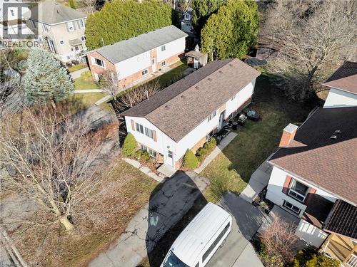 Split-level residence featuring white siding and brown shutters, a brown shingle roof, and a mature tree in the front yard - 9 Cherry Street, Simcoe, ON - Outdoor