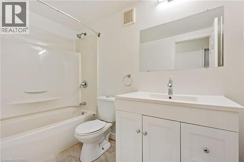 Bathroom featuring a white vanity with an integrated sink, chrome faucet, and a large wall-mounted mirror - 9 Cherry Street, Simcoe, ON - Indoor Photo Showing Bathroom