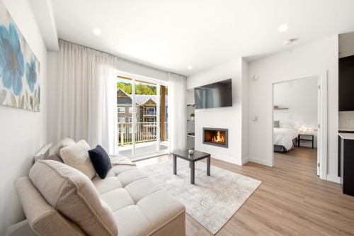 Living Room - 303-240 Rue Du Cercle-Des-Cantons, Bromont, QC - Indoor Photo Showing Living Room With Fireplace