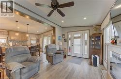 Open-concept living space featuring wood-finish flooring, recessed lighting, and a ceiling fan - 