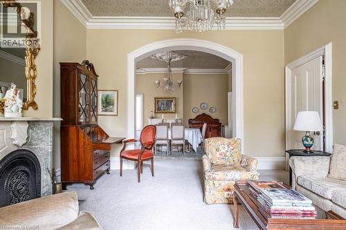 Elegant living space featuring a marble fireplace with an ornate mantel and cast iron firebox - 370 Hess Street S, Hamilton, ON - Indoor Photo Showing Living Room